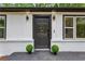 Striking front door with modern lighting and landscaping, inviting you to discover the beauty within at 2554 Gordon Se Cir, Smyrna, GA 30080