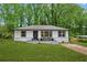 Charming renovated home featuring updated paint, landscaping, new roof, and stylish front porch perfect for relaxing at 2554 Gordon Se Cir, Smyrna, GA 30080