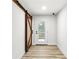 Hallway with stylish sliding barn door and exterior door access at 2554 Gordon Se Cir, Smyrna, GA 30080
