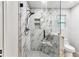 Modern shower featuring glass doors, marble-like tiles, and a built-in niche at 2554 Gordon Se Cir, Smyrna, GA 30080