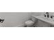 Elegant half-bathroom with a pedestal sink and modern fixtures at 235 Strawberry Ln, Woodstock, GA 30189