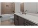 A well lit bathroom featuring decorative tile, matte fixtures, and a large vanity at 235 Strawberry Ln, Woodstock, GA 30189