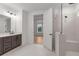Bathroom boasting a double vanity, glass shower, and access to the bedroom at 235 Strawberry Ln, Woodstock, GA 30189