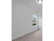 Neutral bedroom featuring carpet and a single window overlooking the backyard at 235 Strawberry Ln, Woodstock, GA 30189