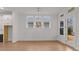 A dining area featuring a view to the backyard, a modern light fixture, and hardwood floors at 235 Strawberry Ln, Woodstock, GA 30189