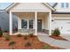 Welcoming front porch with stone accents and contemporary gray front door at 235 Strawberry Ln, Woodstock, GA 30189