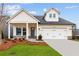 Charming home featuring white siding, stone accents, and a convenient two-car garage at 235 Strawberry Ln, Woodstock, GA 30189