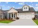 Charming home featuring white siding, stone accents, and a convenient two-car garage at 235 Strawberry Ln, Woodstock, GA 30189