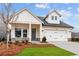 Charming home featuring white siding, stone accents, and a convenient two-car garage at 235 Strawberry Ln, Woodstock, GA 30189