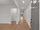 Inviting hallway with hardwood floors and white trim, leading to various rooms at 235 Strawberry Ln, Woodstock, GA 30189