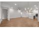 A bright living room features hardwood floors, recessed lighting, and a modern chandelier at 235 Strawberry Ln, Woodstock, GA 30189