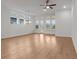 Spacious living room with lots of natural light, hardwood floors, and a modern light fixture at 235 Strawberry Ln, Woodstock, GA 30189