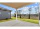 Covered patio with view to backyard and distant treeline at 235 Strawberry Ln, Woodstock, GA 30189
