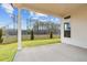 Relax on this covered back patio with a green lawn at 235 Strawberry Ln, Woodstock, GA 30189