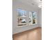Bright room featuring hardwood floors and large windows for natural light at 235 Strawberry Ln, Woodstock, GA 30189