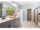 Bathroom featuring double sinks, gray cabinets, and a glass shower at 26 Kensington St, Kingston, GA 30145