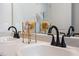 Close-up of a bathroom vanity with marble countertops, black faucets and decorative accents at 26 Kensington St, Kingston, GA 30145
