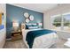 Bedroom featuring an accent wall, a large window with blinds, and coordinated furnishings at 26 Kensington St, Kingston, GA 30145