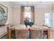 Elegant dining room with a rustic wooden table, comfortable seating, and stylish pendant lighting at 26 Kensington St, Kingston, GA 30145