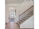 Hallway with beautiful hardwood floors, decorative wall trim, with view of stairs and front door at 26 Kensington St, Kingston, GA 30145