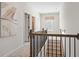 Second floor hallway showcasing stairs, carpeted floors and wood railing at 26 Kensington St, Kingston, GA 30145