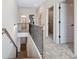 Upstairs hallway showcasing carpeted floors, spindle railing and access to multiple rooms at 26 Kensington St, Kingston, GA 30145
