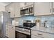 Kitchen details include stainless steel appliances, gray cabinets, granite countertops, and tiled backsplash at 26 Kensington St, Kingston, GA 30145