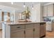 Close-up of kitchen island featuring granite countertops, stainless steel dishwasher and sink at 26 Kensington St, Kingston, GA 30145