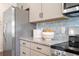 Modern kitchen features granite countertops, stainless steel appliances and neutral backsplash at 26 Kensington St, Kingston, GA 30145