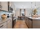 Modern kitchen with stainless steel appliances, granite countertops, and an open design overlooking dining area at 26 Kensington St, Kingston, GA 30145