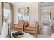 Inviting living room with leather armchairs, modern art, and hardwood flooring provides a stylish and comfortable space at 26 Kensington St, Kingston, GA 30145