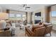 Bright living room featuring a fireplace, large windows, ceiling fan, and comfortable seating at 26 Kensington St, Kingston, GA 30145