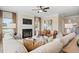 Bright living room featuring a fireplace, large windows, ceiling fan, and comfortable seating at 26 Kensington St, Kingston, GA 30145