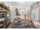 Home office with large window, neutral walls, decor, and built in shelving unit at 26 Kensington St, Kingston, GA 30145