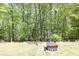 Backyard featuring a fire pit and wooded area at 2945 Barimore Pl, Dacula, GA 30019