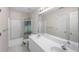 Bright bathroom features a double sink vanity, tub with shower, and a neutral color palette at 2945 Barimore Pl, Dacula, GA 30019