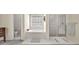 Bright bathroom featuring a garden tub, separate shower, and plenty of natural light at 2945 Barimore Pl, Dacula, GA 30019