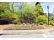 Community entrance sign for 'Barimore' set amidst landscaped flowers and greenery at 2945 Barimore Pl, Dacula, GA 30019