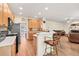 Open-concept kitchen with bar seating that flows into the home's living area at 2945 Barimore Pl, Dacula, GA 30019