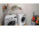 Functional laundry room featuring modern LG washer and dryer, with overhead storage shelves at 2945 Barimore Pl, Dacula, GA 30019