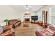 Spacious living room featuring a fireplace, ceiling fan, and large windows at 2945 Barimore Pl, Dacula, GA 30019