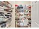 Pantry with shelving stocked full of a variety of food items and supplies at 2945 Barimore Pl, Dacula, GA 30019