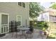 Outdoor patio area with a table, chairs, and a fire pit at 2945 Barimore Pl, Dacula, GA 30019