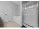 Bright bathroom with a built-in tub and separate glass-enclosed shower, offering a modern space at 3203 Cyrus Point Nw Ln, Kennesaw, GA 30152