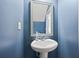 Bathroom with pedestal sink and blue painted walls at 3203 Cyrus Point Nw Ln, Kennesaw, GA 30152