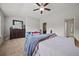 Bedroom featuring a neutral carpet, ceiling fan, and large dresser with mirror at 3203 Cyrus Point Nw Ln, Kennesaw, GA 30152