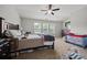 Spacious bedroom with neutral carpet, ceiling fan and natural light from three windows at 3203 Cyrus Point Nw Ln, Kennesaw, GA 30152