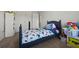 Comfortable bedroom with blue bed, ample toy storage, and soft, neutral carpet at 3203 Cyrus Point Nw Ln, Kennesaw, GA 30152