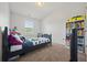 Bright bedroom offers a cozy bed, storage shelves, and a large window for natural light at 3203 Cyrus Point Nw Ln, Kennesaw, GA 30152