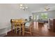 Cozy dining area with wood table and chairs, hardwood floors, chandelier, and view to the living room at 3203 Cyrus Point Nw Ln, Kennesaw, GA 30152
